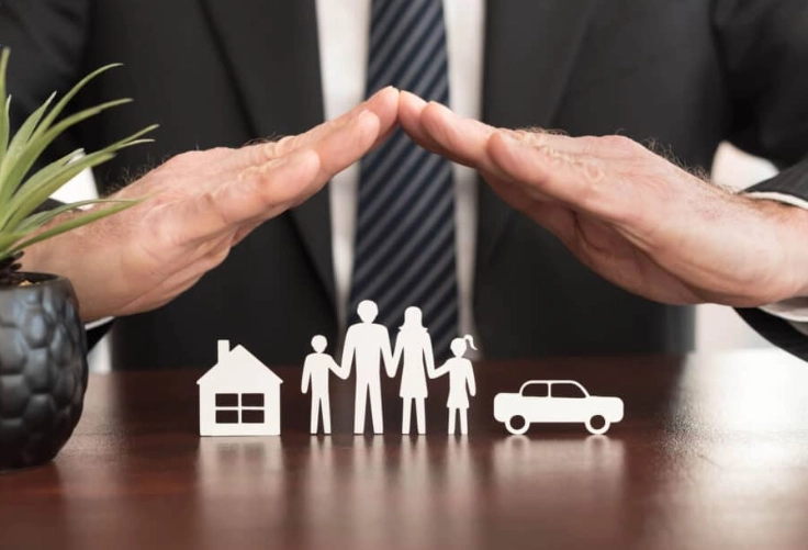 Hands on a table covering the toys, resembling the hands of family members standing nearby