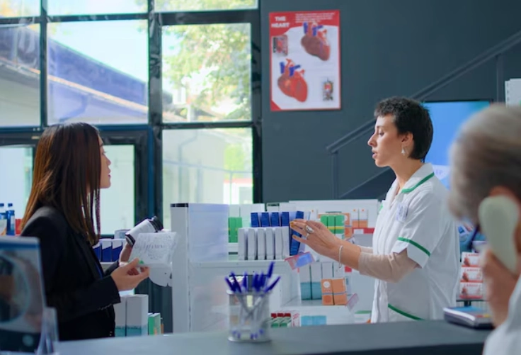 The sales person explains the new pharmaceutical device to the customer during the training session.